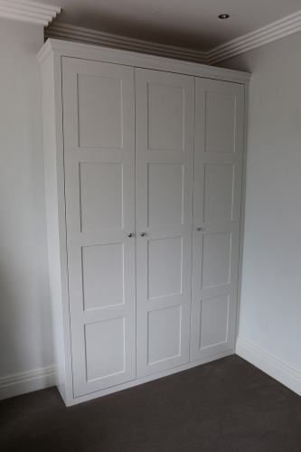 Fitted wardrobe with four panelled doors